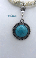 Collier de perles Tatiana fait avec des perles blanches et insertion de perles vertes très pale le tout fini avec un fermoir a bascule et au centre en avant il a un magnifique pendentif de couleur turquoise. Il mesure 52 centimètres et son pendentif est de 4 centimètres.