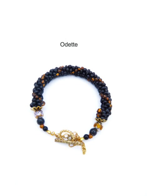 Magnifique bracelet  de perles de verre fait au crochet avec des perles de verre noires et insertion de perles or. Un fermoir à bascule or