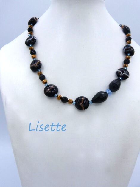Collier de perles Lisette est composé de grosses perles noires avec des plus petites et des perles brunes et deux petites perles transparentes et un fermoir a bascule facile pour attacher. Modèle : Lisette Fermoir qui est aussi décoratif. Dimension: 49 cm.