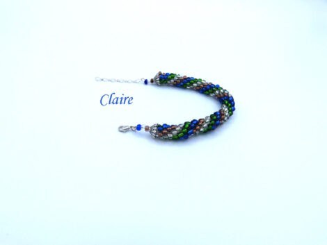 Bracelet de perles de verre Claire fait au crochet avec des perles verte et insertion de perles bleu et brunes, le tout terminé par un fermoir à pince de homard argent il mesure 17 a 21 cm